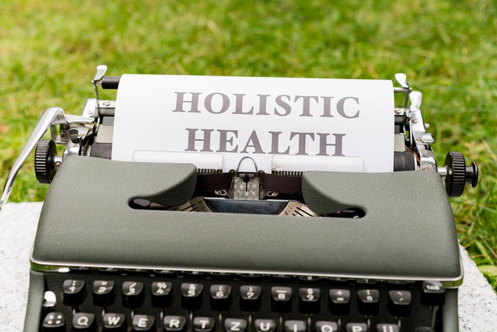 A typewriter with the word holistic health written on it